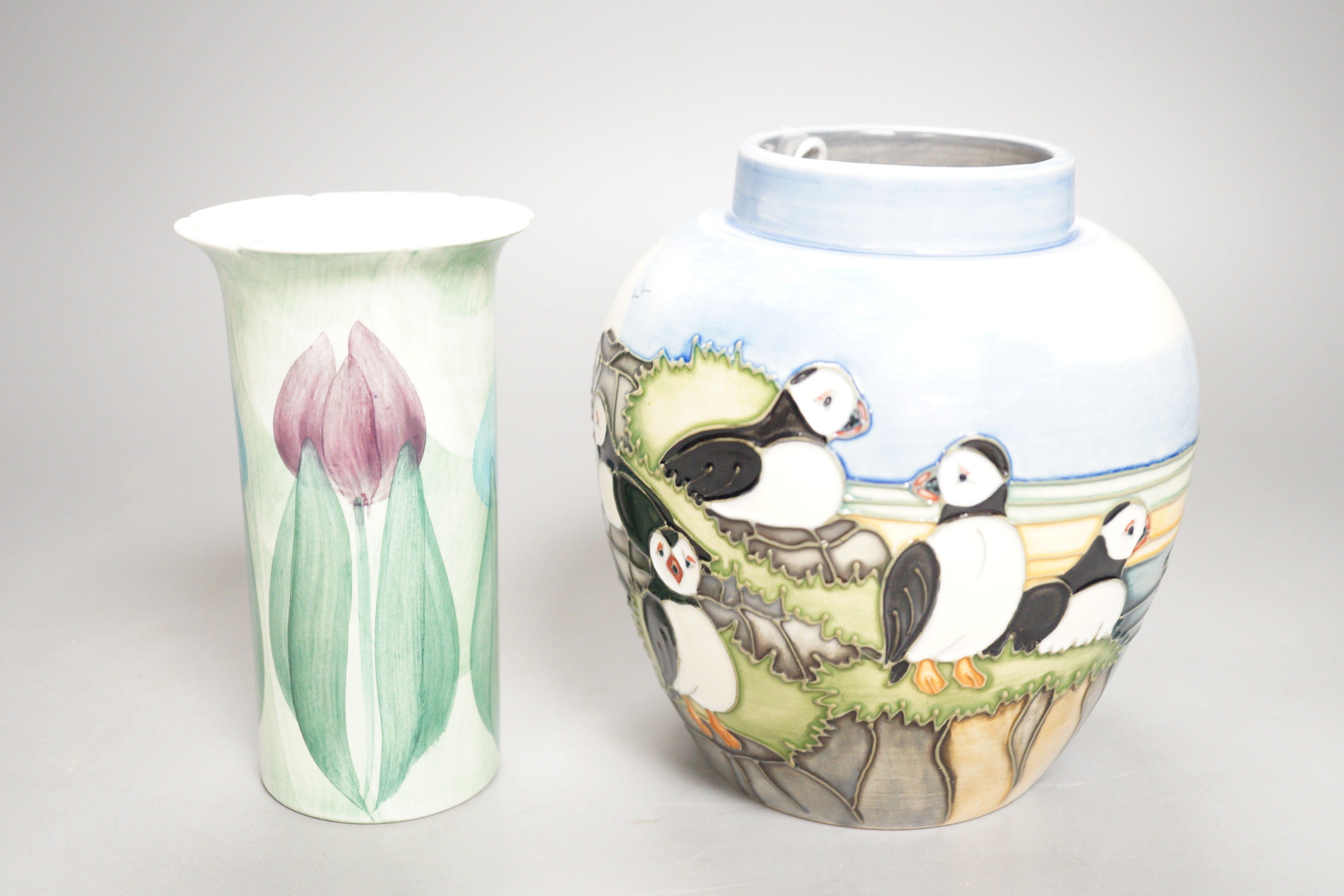 A Moorcroft pottery jar, decorated with puffins and a Jersey pottery 